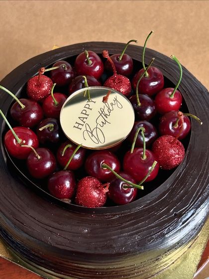 A birthday version of my Cherryoclate cake. The top is a bouquet of fresh Himachal cherries, making it as beautiful as it is delicious.
