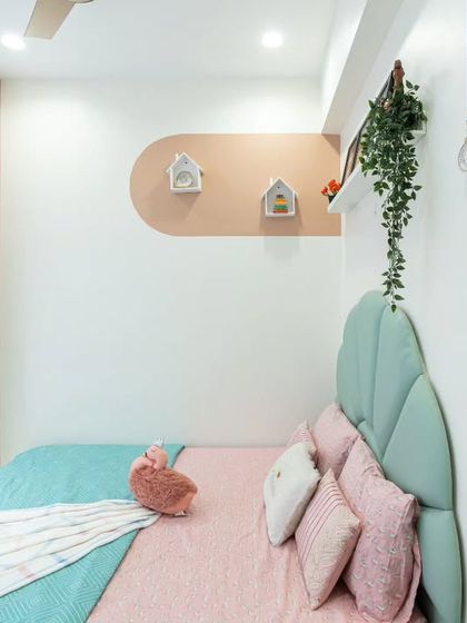 Details like the hanging medals and the small house-shaped shelves make this room truly personal. We believe in creating spaces that reflect the child's achievements and hobbies.