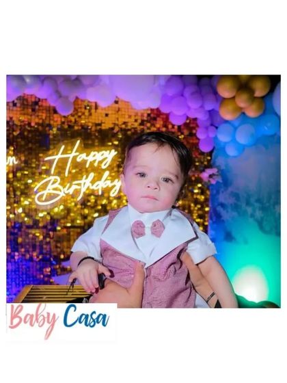 A close-up of our birthday boy's outfit. The dusty rose vest and bow tie create a soft yet formal look, perfect for a first birthday photoshoot.