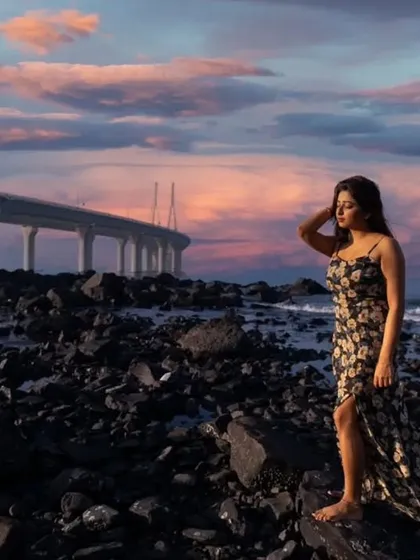 The dramatic Mumbai skyline meets a moment of quiet contemplation. This portrait uses the stunning sunset and the iconic Bandra-Worli Sea Link to create a cinematic and atmospheric fashion shot.