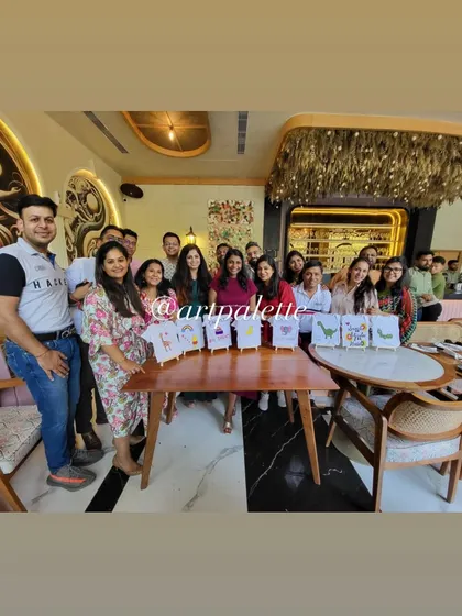 The proud artists and their finished masterpieces. This group had a wonderful time at a restaurant creating a whole set of unique, hand-painted onesies for a very loved baby.