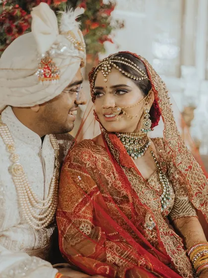 The look they share speaks volumes. Seated together during the pheras, this candid shot captures the deep connection and quiet understanding between the bride and groom.