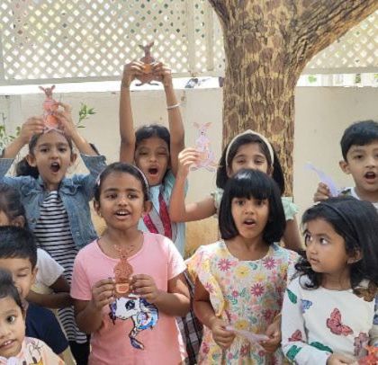 Roaring with excitement! The children show off the animal crafts they made during summer camp. Group activities like this are full of energy and shared creativity.