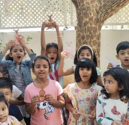 Roaring with excitement! The children show off the animal crafts they made during summer camp. Group activities like this are full of energy and shared creativity.