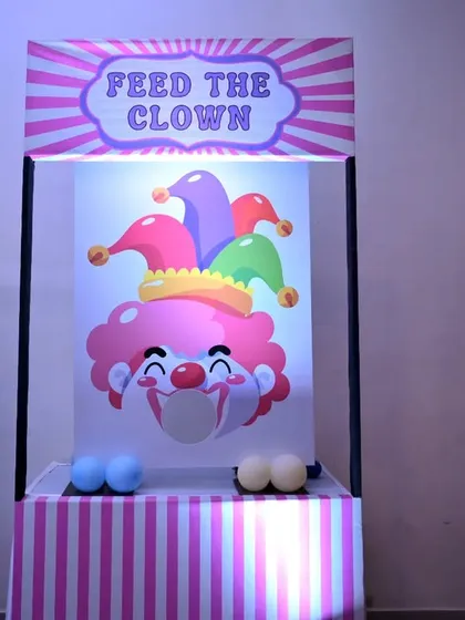 Fun and games are a must! We set up this 'Feed the Clown' game stall, complete with balloon pillars, to keep the little guests entertained at the circus party.