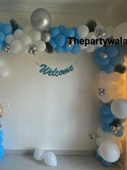 Another angle of the "Welcome Home" decor, showing the blue and white balloon arch and a cute baby foil balloon.