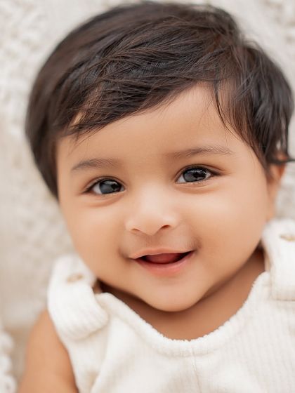 A beautiful close-up of a smiling baby's face.