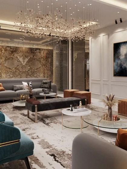 This living room interior demonstrates our skill in mixing materials to create a rich, layered look. A feature wall of textured marble, a mirrored surface reflecting a stunning chandelier, and plush velvet seating come together for an opulent effect.