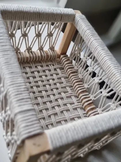 An overhead view of the empty macrame basket, showing the intricate woven bottom that provides a solid and stable base.