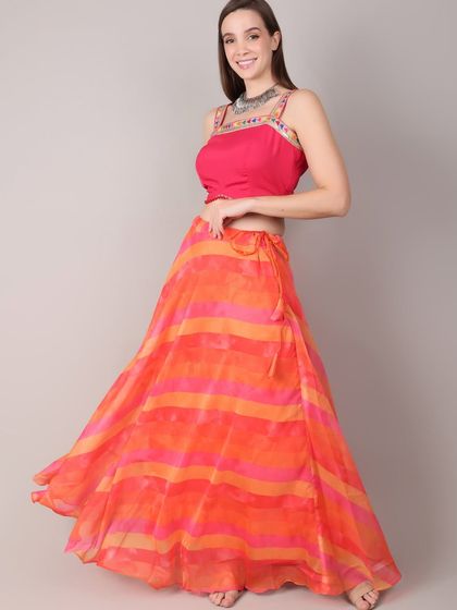 This elegant orange and pink striped lehenga is perfect for festive evenings and graceful dandiya nights. The lightweight fabric and bright colors blend tradition with modern sophistication.