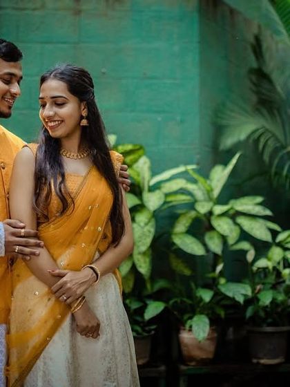 A beautiful couple portrait taken during their Haldi event. The soft light and natural background create a lovely, romantic feel.