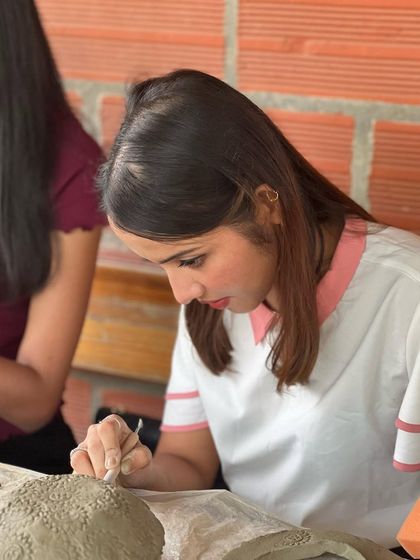 The focus and calm on this participant's face says it all. Pottery is a meditative experience that provides a much-needed creative break from the daily work routine.