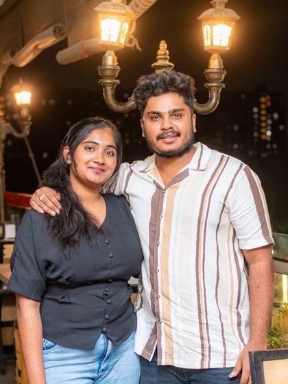 A couple enjoying the warm lighting of the rooftop area.