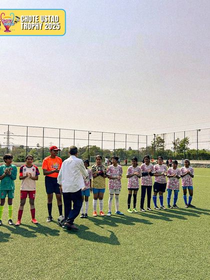 Our girls' team lines up before a match at the Chote Ustad Trophy. We teach sportsmanship and respect for the game and opponents.
