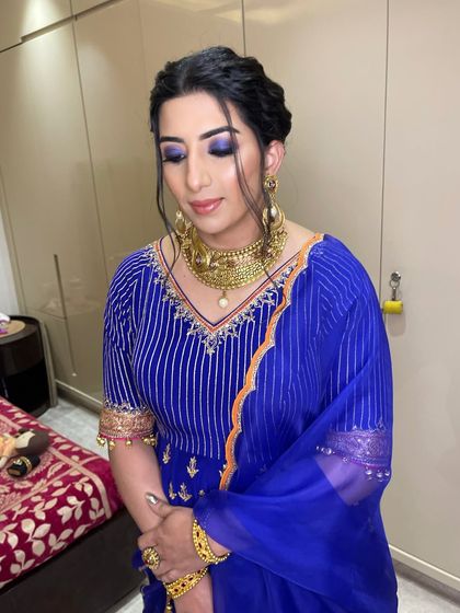 With eyes closed, you can appreciate the artistry of the blended blue eyeshadow, a perfect choice for a festive party look.