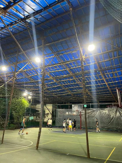 Here's another angle of the court, showing the sturdy structure that keeps it covered and ready for play year-round. Whether you're practicing shots or in a full-court game, the space is all yours.