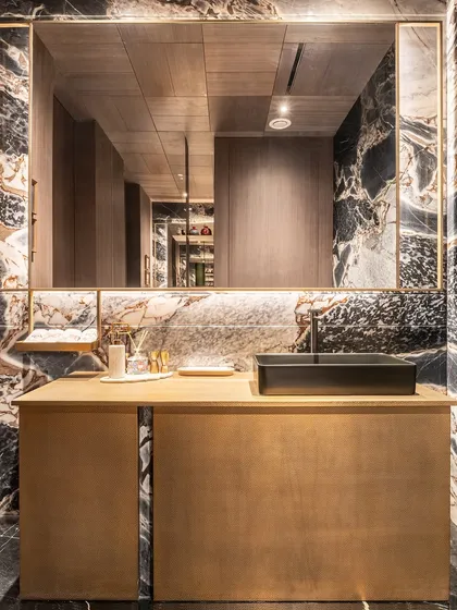 We believe a bathroom should be a private retreat. This moody, dramatic space demonstrates our material-led approach, using bold Prada White and Armani Bronze stone to create a sanctuary that moves far beyond the purely functional into a realm of sculptural, personal luxury.