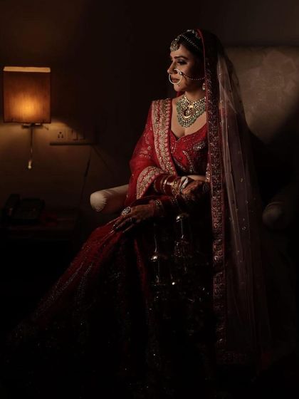 A full-length shot of the bride in a softly lit, elegant pose. She looks like a painting.