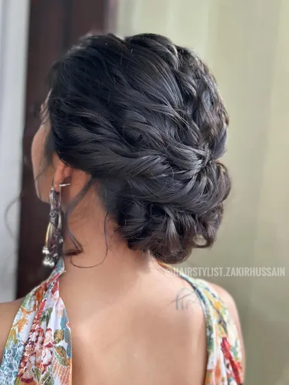 A complex and beautiful updo with multiple braids woven together. This style is a work of art and is perfect for a bride who wants a truly unique look.