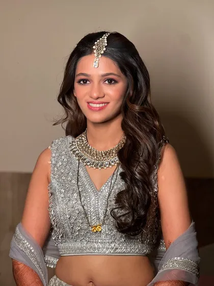 My bride Jaee looking stunning for her reception in a silver-grey lehenga with soft, natural makeup.