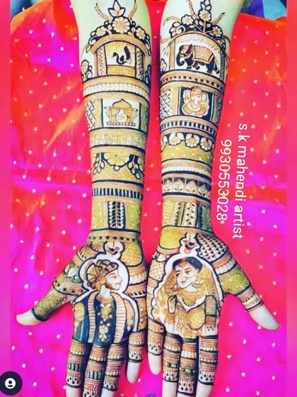 A royal-themed design with portraits of the couple. The arms are filled with elephants, wedding symbols, and palace architecture.