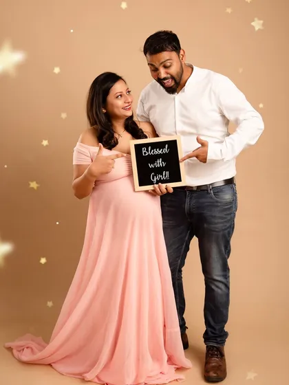 A sweet and simple gender reveal. The couple's excited expressions and the "Blessed with a Girl" sign make for a joyful and heartwarming announcement.