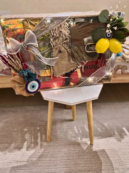 A groom's hamper from the Moroccan collection, featuring a Hugo Boss gift, evil eye charms, and fairy lights for a touch of magic. The entire presentation is designed to feel both masculine and thematically rich.