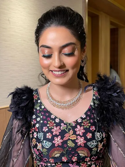 A dreamy Sangeet look. I balanced elegance with playful glam using soft shimmer lids, radiant skin, and pearl detailing in her hair.