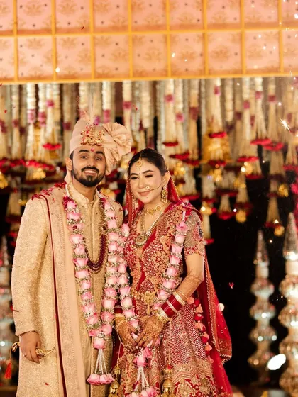 The happy couple after their varmala ceremony, surrounded by the warm glow of the lights and the beauty of the floral decor.