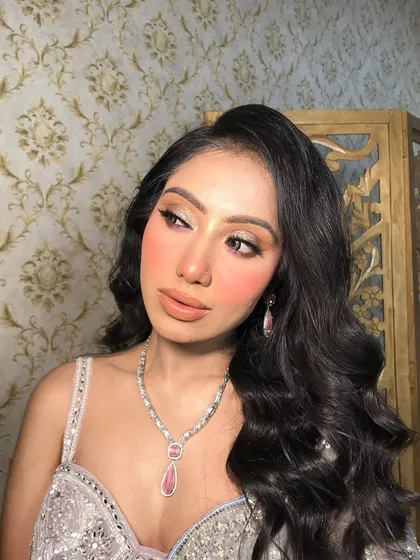 A close-up of this client's look, featuring a delicate pink-stoned American diamond necklace and matching drop earrings.