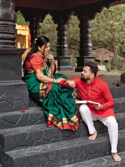 A candid, interactive moment from the traditional shoot. The couple is seen sharing a quiet conversation on the temple steps, adding a layer of authentic storytelling to their session.