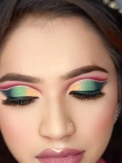 A close up of a colorful and artistic eye makeup look created during a makeup class. My academy offers comprehensive training in both hair and makeup.