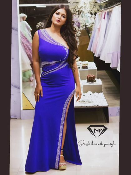 This royal blue gown is all about modern glamour. I designed it with a one-shoulder silhouette and crystal embellishments that trace the curves, finished with a high slit for that perfect power pose.