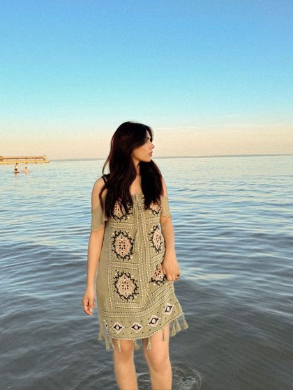 Wading into the water at Crystal Beach during sunset. This shot, featuring a boho-style dress, creates a serene and beautiful summer moment.