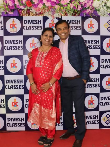 Prof. and Mrs. Parab posing together on the red carpet, the guiding force behind our success.
