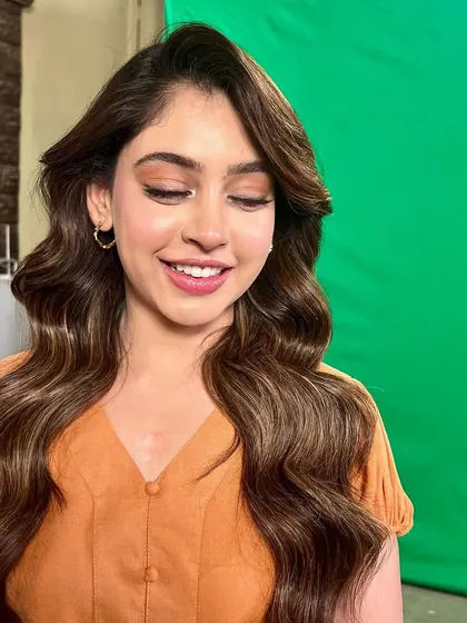 A close-up of her soft eye makeup and radiant smile.
