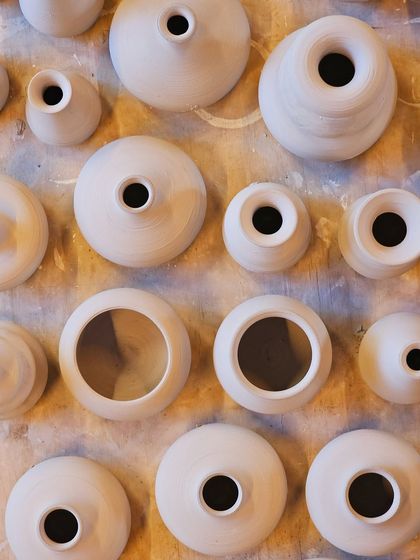 Fresh off the wheel and full of personality. These pieces are waiting to be fired, each one telling the story of its creator.