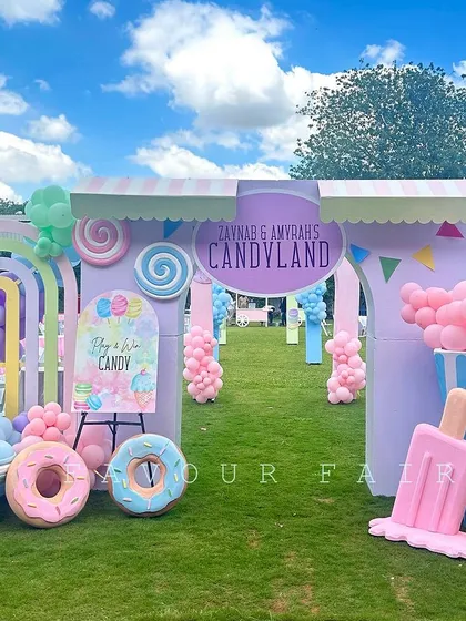 Welcome to the sweetest party in town. We designed this sprawling outdoor Candyland theme with a grand entrance, giant pastel lollipops, donuts, and ice cream props, creating a whimsical wonderland for guests to explore.