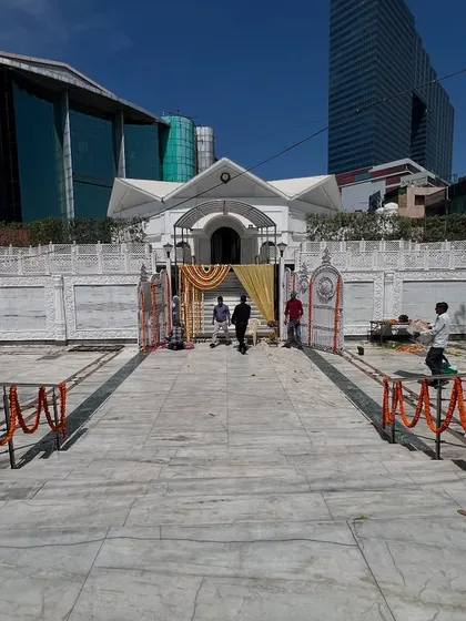 A wide view of the venue entrance, showing the simple and respectful decoration for a religious ceremony.