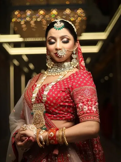 The final touches on a beautiful bride. This image showcases the intricate details of the jewellery and the flawless makeup application that brings the entire look together.