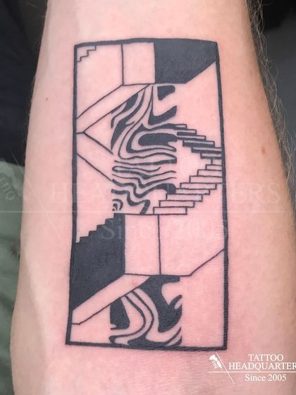 An abstract geometric tattoo with stairs and fluid patterns, reminiscent of an M.C. Escher piece.