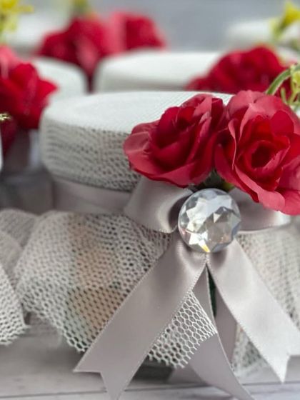 Handcrafted 'Thank you' jars filled with almonds, beautifully decorated with red roses. These were made as return favours for a Navratri celebration.