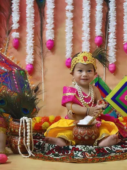 Celebrating our beautiful culture with a Janmashtami themed photoshoot. This little Krishna, with his peacock feather and pot of butter, looks absolutely divine in this detailed studio setup filled with traditional props.