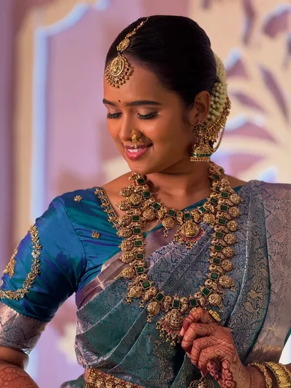A candid, raw photo of my bride Swathy during her Muhurtham. Her gentle smile and the soft lighting highlight the natural, subtle makeup I created to ensure she felt comfortable and beautiful.