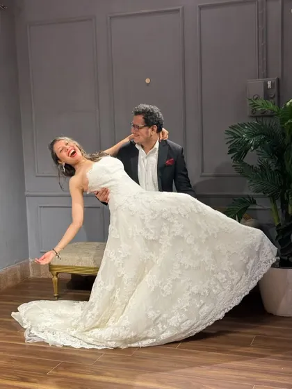 Capturing the joy of a special day. This couple looks fantastic in our rental outfits, a classic black suit and a beautiful white lace wedding gown.