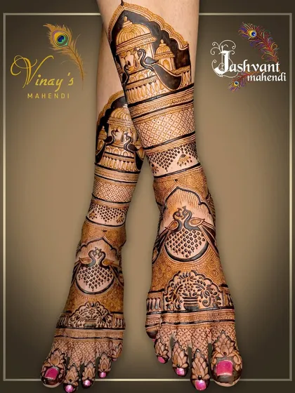 A full-leg bridal design featuring palace architecture and peacocks. The artwork is dense, detailed, and perfect for the bride who wants a truly grand statement.