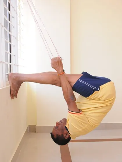A supported backbend using the rope. This variation helps to open the upper back and shoulders, areas that are often tight from sitting.
