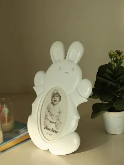 Add a touch of magic to your little one’s world with this adorable white bunny photo frame. Its playful design and soft hue make it a lovely addition to any nursery or playroom.