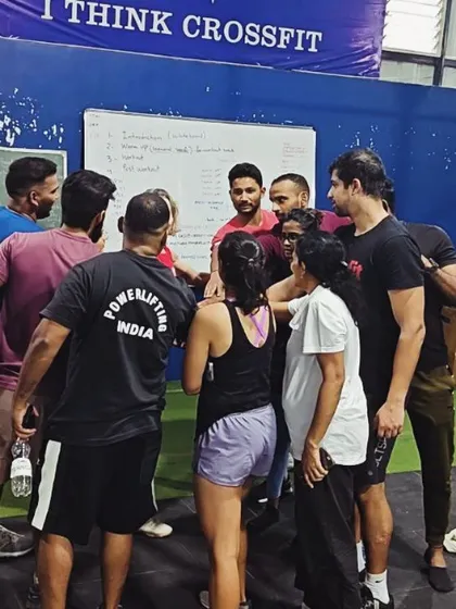 A group of trainers huddles up during a CrossFit certification course hosted at our facility. We love fostering collaboration and learning within the wider community.