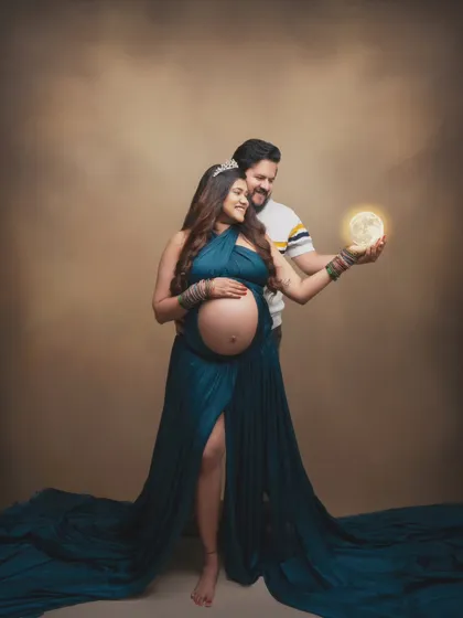 Holding a world of dreams in her hands. This magical portrait combines a flowing gown and a glowing moon prop to create a sense of wonder and fantasy, celebrating the miracle of new life.